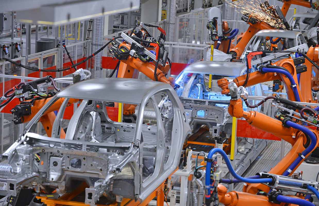 robots welding in an automobile factory